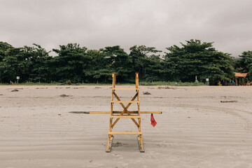 chair for lifeguards on the beach. yellow lifeguard bench. beach with lifeguards.