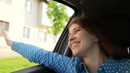 happy girl rides with her hand out window, car rides journey road, portrait woman fun road, Enjoy...