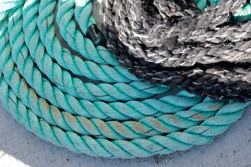 Textured ropes, coiled ropes, fisherman's boat