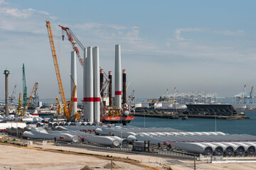 Port of Le Havre northern France. 2023. Offshore wind turbine installation ship loading turbine blades  bound for St Brieuc wind farm, off Brittany. - obrazy, fototapety, plakaty