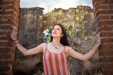 portrait of a latin woman in some ruins on her destination trip. travel lifestyle concept