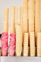 blank ice cream wafers. Waffle cones in an ice-cream shop, Italy. A variety of sugar-free vegan ice cream with natural ingredients on display at the Italian gelateria. Natural fresh ice cream. - 614297585
