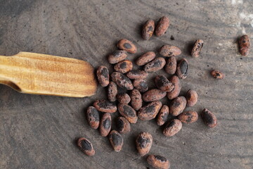 Cacao beans being roasted on a traditional comal plate to prepare chocolate