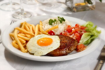 filet on horseback, classic Brazilian tavern dish, with rice, fried egg and meat