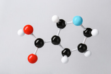 Molecule of vitamin B3 on light grey background. Chemical model