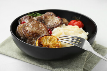 Tasty beef tongue pieces, berries, lemon, rosemary, tomato and mashed potatoes on white table, closeup