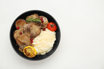 Tasty beef tongue pieces, berries, lemon, rosemary, tomato and mashed potatoes on white table, top view. Space for text