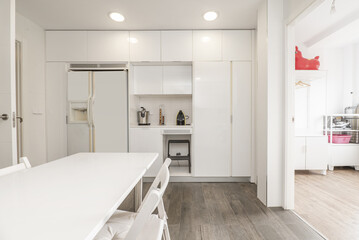 Spacious kitchen with bright white cabinets