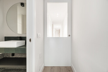 corridor of a house with a glass door