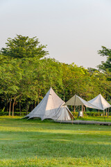 Fototapeta na wymiar Tents on the Camping Grassland in the Morning Park