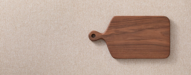 Walnut handmade wood cutting board on the linen. Wooden cutting board. Wooden chopping board.