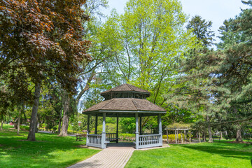 Rosetta McClain Gardens cabin shade made of wood and surrounded by gardens trees. Picturesque public garden located in Scarborough, Ontario, Canada. Scarborough Bluffs area.