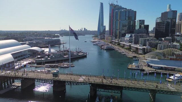 Drone aerial scenic shot of Australian Flag Darling Harbour Sydney Navy Ship bridge travel tourism CBD NSW Australia Maritime Museum 4K