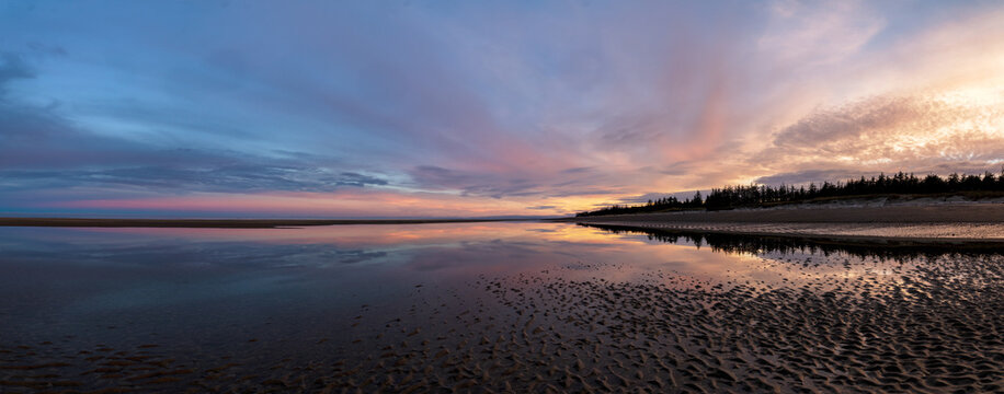 Panorama of sunset at low tide on beach at Cape Fife, Haida Gwaii, BC, Canada