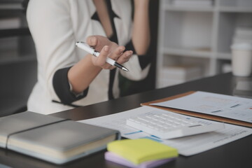Shot of a asian young business Female working on laptop in her workstation.