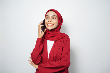Fototapeta premium Asian Muslim businesswoman in red casual make a call isolated by a white background