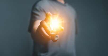 Idea concept creative, inspiration Business Man holding illuminated light bulb, innovation, thinking, technology concept. Concept of creativity, shine bulbs, solution, strategy, new ideas, Imagination