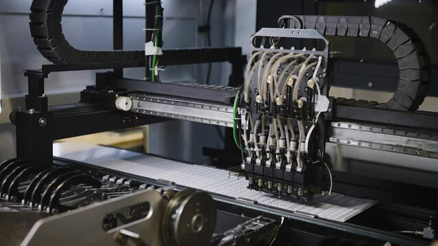 Factory for the assembly of LED lamps. High-tech machine for placing LEDs on panels.