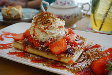 A strawberry waffle on the table