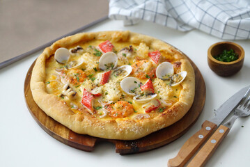 Photo of seafood pizza on the table
