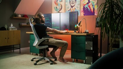 Male trader analyzes real-time stocks, exchange market charts on multi-monitor computer workstation, eats delivery food. Man works in investment in cozy room at home office. Cryptocurrency trading.