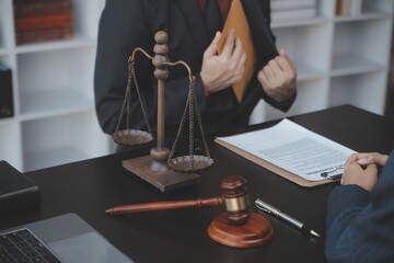 Business and lawyers discussing contract papers with brass scale on desk in office. Law, legal...