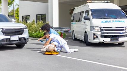 Two paramedic rescuers helping a patient after having an accident. African nurse works with her...