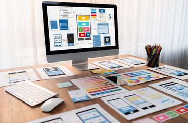 Digital and paper wireframe designs for web or mobile app UI UX display on laptop computer screen....