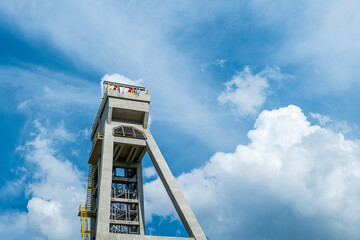 The tower of the formThe tower of the former mine shaft against the blue sky. Currently an observation tower. Shaft President, Chorzow, Poland - obrazy, fototapety, plakaty