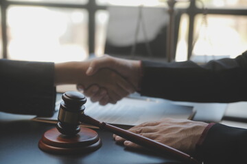 Male lawyer working with contract papers and wooden gavel on tabel in courtroom. justice and law ,attorney, court judge, concept.