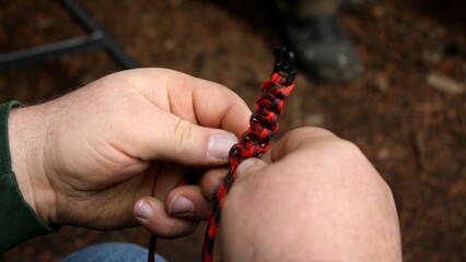 closeup on hands holding paracord 