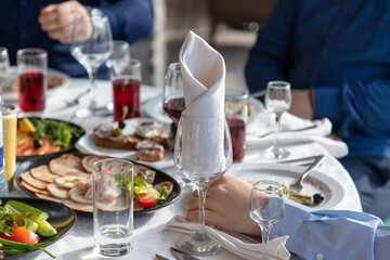 Restaurant table set with wine glasses and snacks
