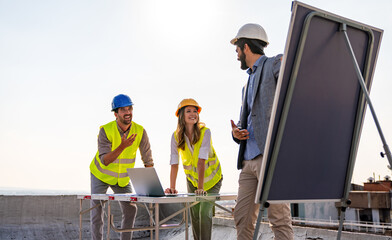 Group of engineers, architects, business partners at construction site working together