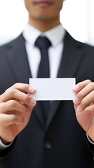 Close up of Businessman holding blank visit card