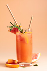 Summer cocktail with grapefruit, rosemary, and ice.