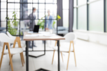 Blurred image of business people standing in the office