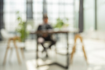 Businessman blur in the workplace in office with computer or shallow depth of focus of abstract background.