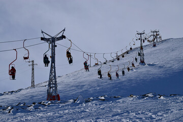 View of the cable car with skiers on Cheget