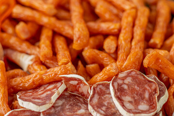 Cured meat with toppings. Homemade salami, chorizo and other cured sausages. Dried sausages cut into thin slices
