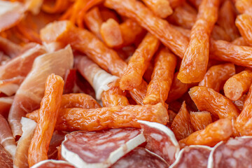 Homemade salami, chorizo and other cured sausages. Dried sausages cut into thin slices