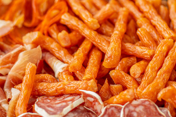 Cured meat with toppings. Homemade salami, chorizo and other cured sausages. Dried sausages cut into thin slices