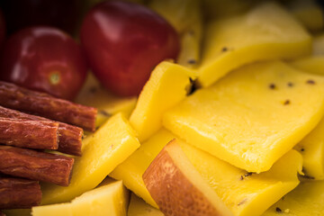 Cheese snacks in one container. Sliced cheese in different shapes. Cheese board for the celebration