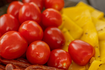 Cheese snacks in one container. Sliced cheese in different shapes. Cheese board for the celebration