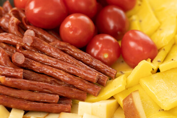 Cured meat with toppings. Homemade salami, chorizo and other cured sausages. Dried sausages cut into thin slices