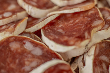 Homemade salami, chorizo and other cured sausages. Dried sausages cut into thin slices