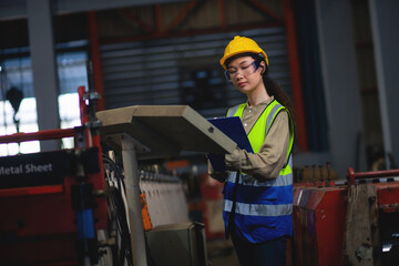 Female engineer working in a factory. Factory safety audit. Smile confident in the work of professional workers.