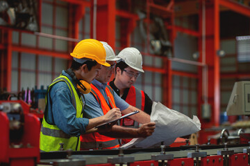 Engineers and skilled workers celebrating success in factory Industrial people and production labor concept success.