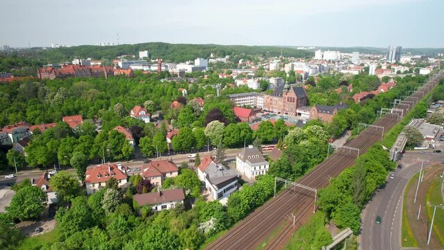Aerial view of traffic on highway in Gdansk City during sunny day surrounded by green trees