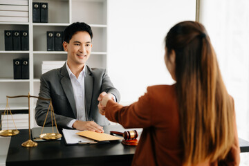 justice and law concept.passing bribe money in the envelop at lawyer office. businessman hand taking bribe money from female.