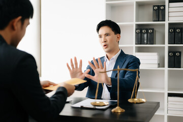 Lawyer refusing bribe money in the envelop from businessman at the lawyer office.